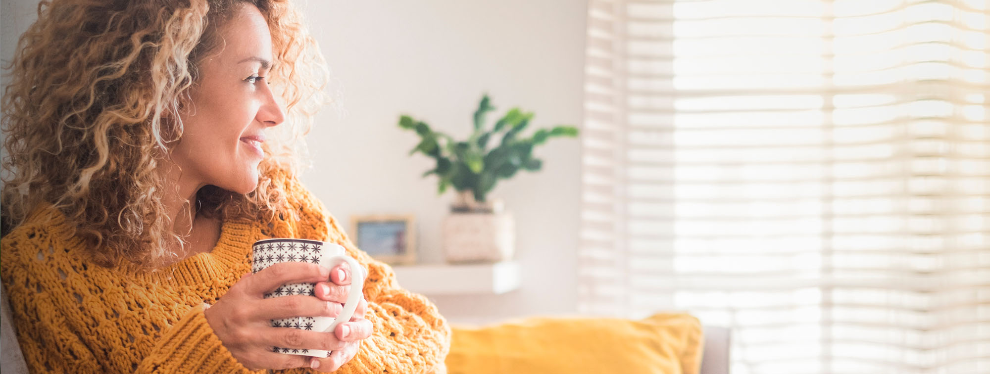 Woman enjoying a cup of coffee at home